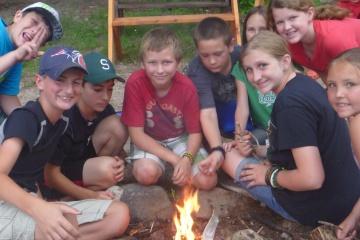 Children gathered around a fire at the Barry Conservation